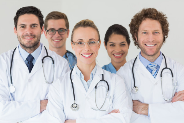 A group of doctors standing together in front of the camera.