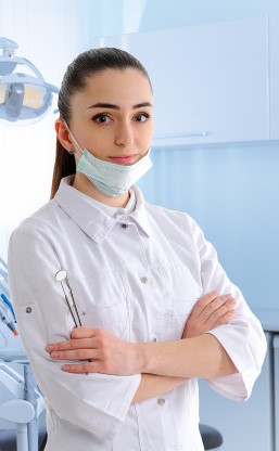 A woman in white shirt and blue pants holding a tooth brush.