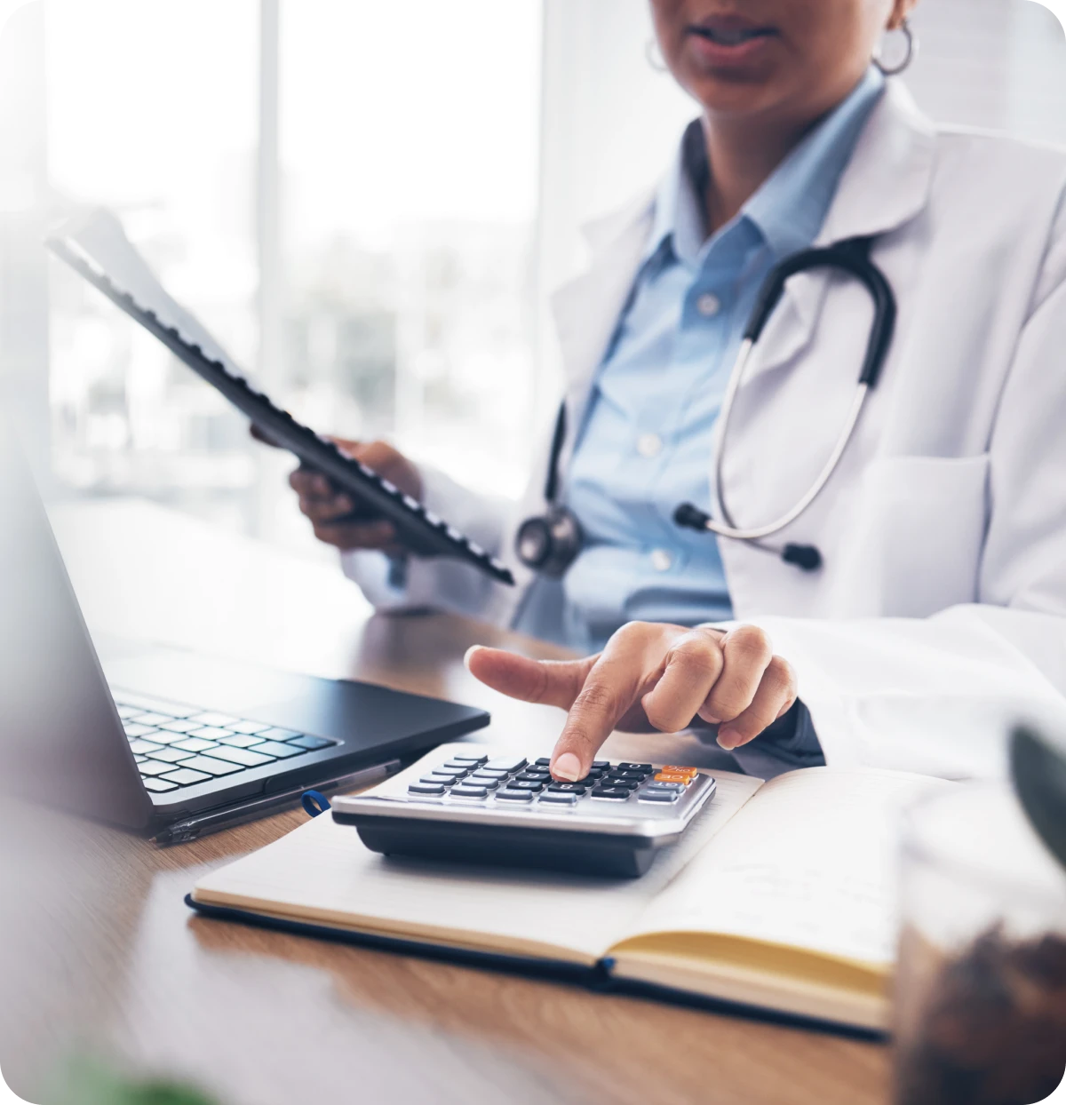 Medical professional calculating expenses