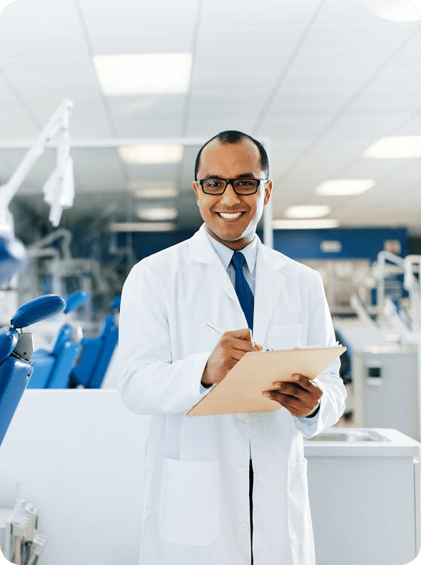 Doctor holding clipboard in dental office