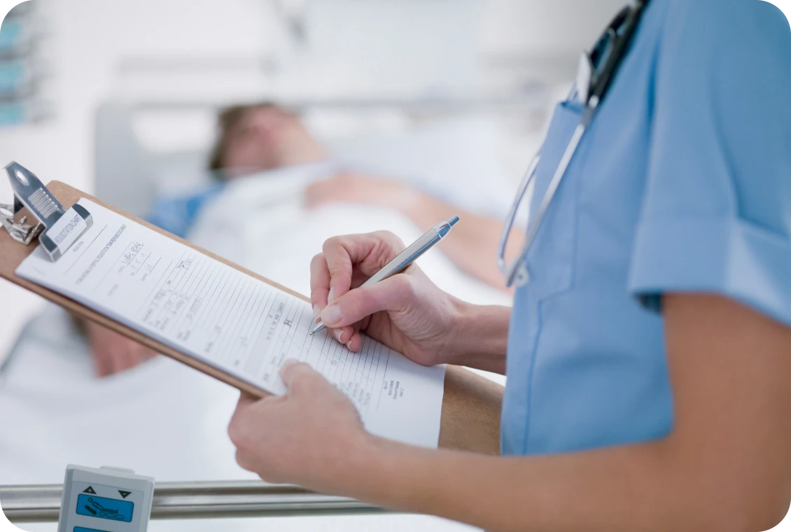 Nurse writing on clipboard in hospital