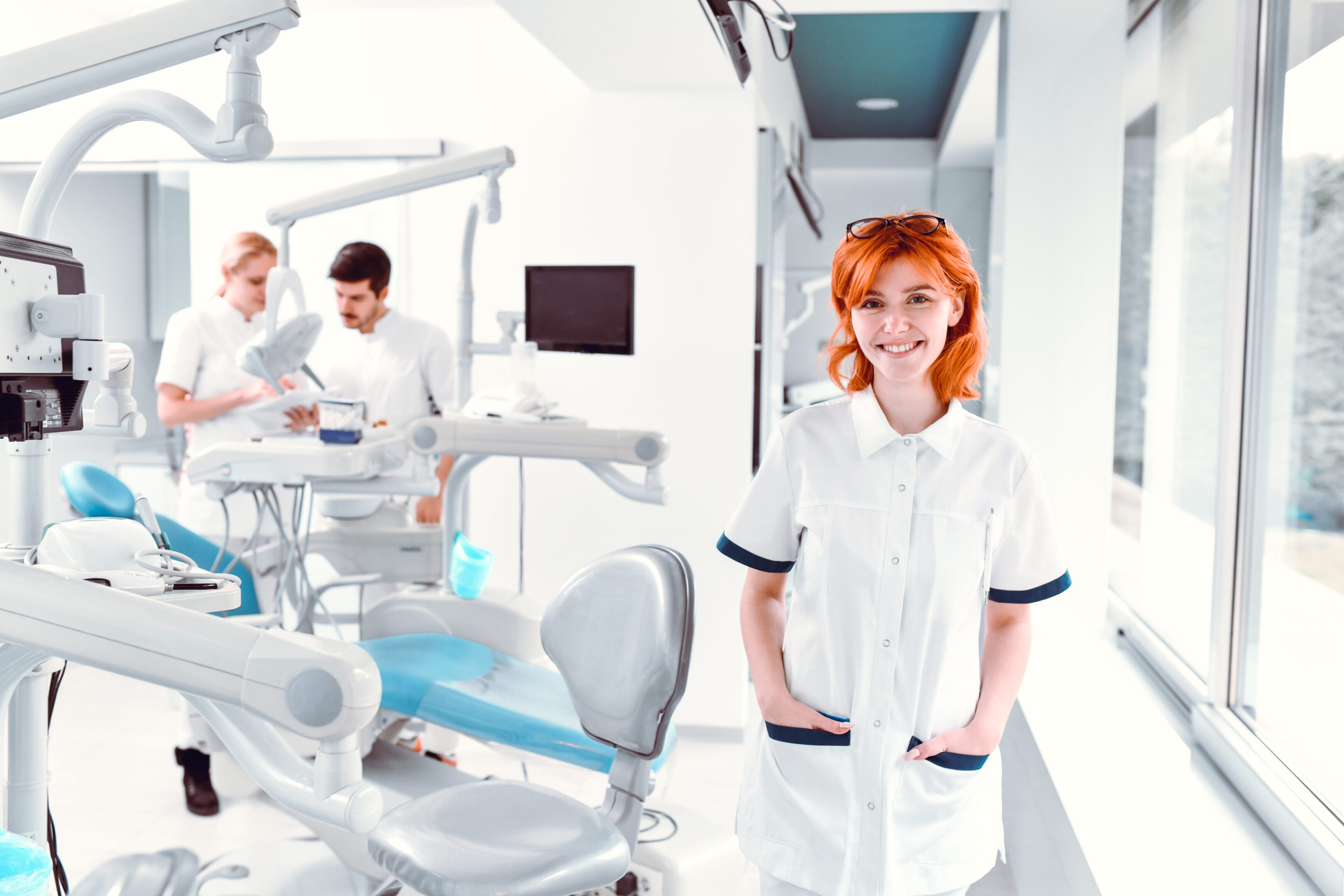 Beautiful Nurse With Her Team In Dental Clinic