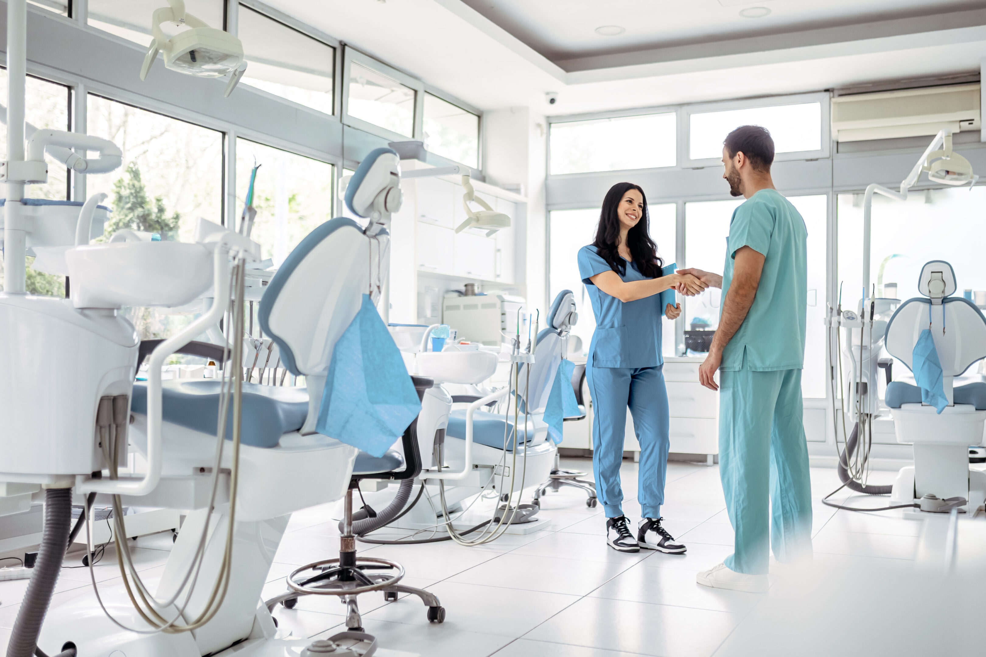 Confident Dentists Standing Together in Modern Clinic